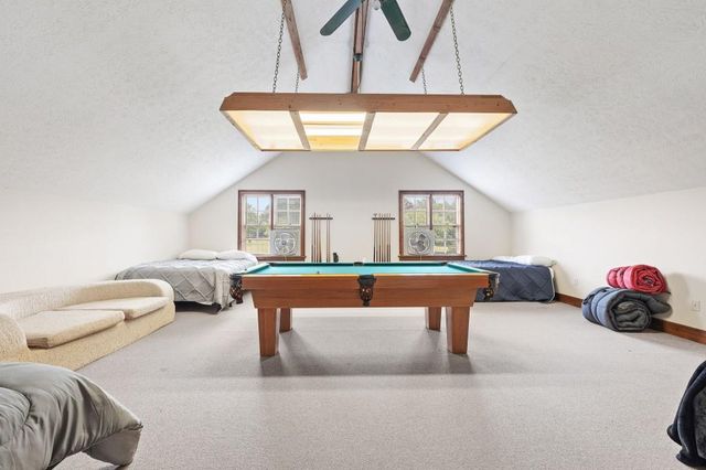 a dining room with furniture and a chandelier