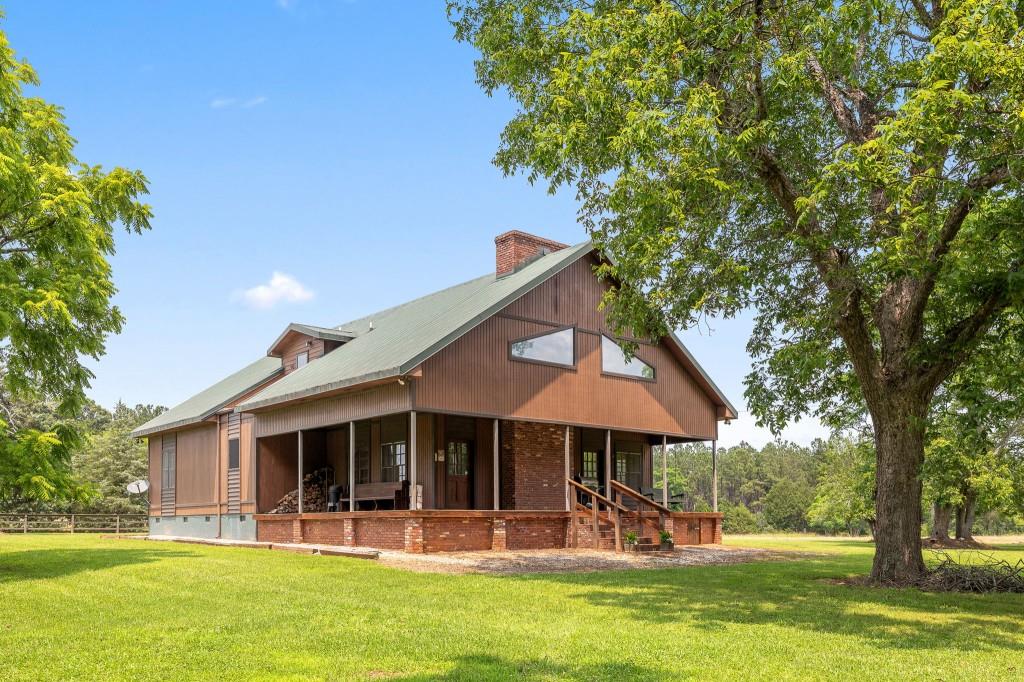 3780 Brownwood Road Madison, GA 30650 - Photo 2 of 25 a view of a house with a yard porch and sitting area