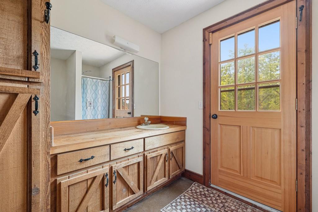 3780 Brownwood Road Madison, GA 30650 - Photo 21 of 25 a bathroom with a sink a vanity and a mirror