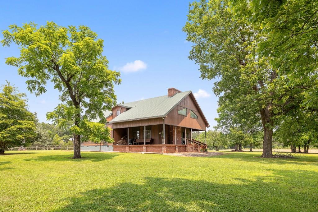 3780 Brownwood Road Madison, GA 30650 - Photo 22 of 25 a front view of a house with a garden