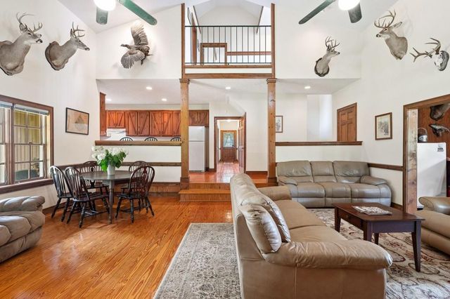 a living room with fireplace furniture and a wooden floor