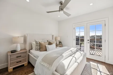 a bedroom with a bed and a lamp on dresser