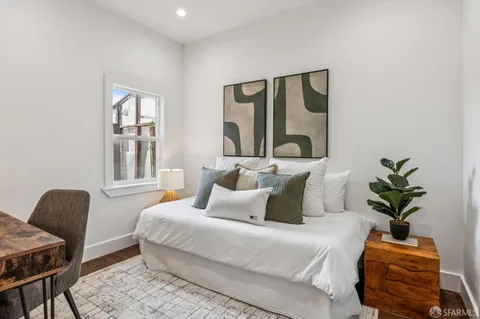 a bedroom with a large bed and a window