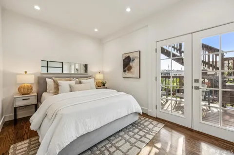 a view of a pathway with a flower plants and wooden fence
