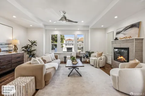 a living room with furniture and a chandelier