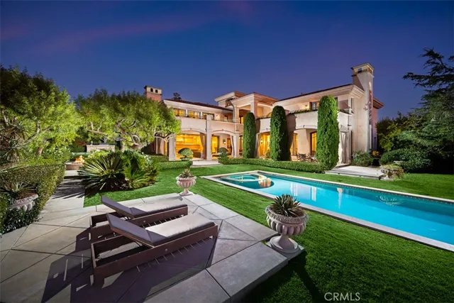 a view of a pool with a table and chairs