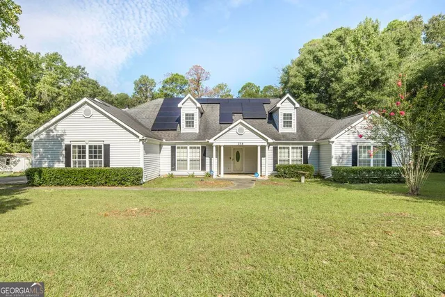 a front view of a house with a garden