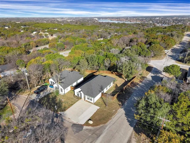 an aerial view of residential houses with outdoor space