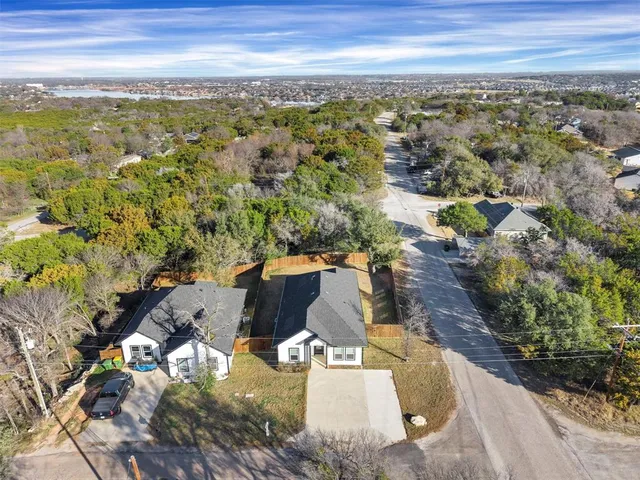 an aerial view of residential houses with outdoor space