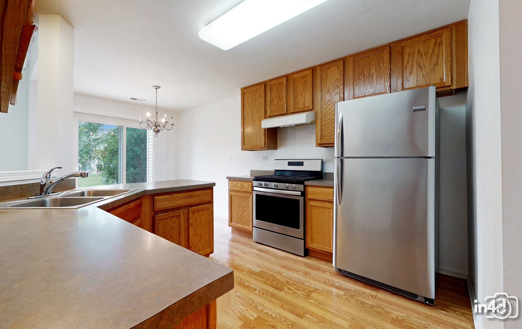529 Metropolitan Street Aurora, IL 60502 - Photo 11 of 29 a kitchen with refrigerator and cabinets