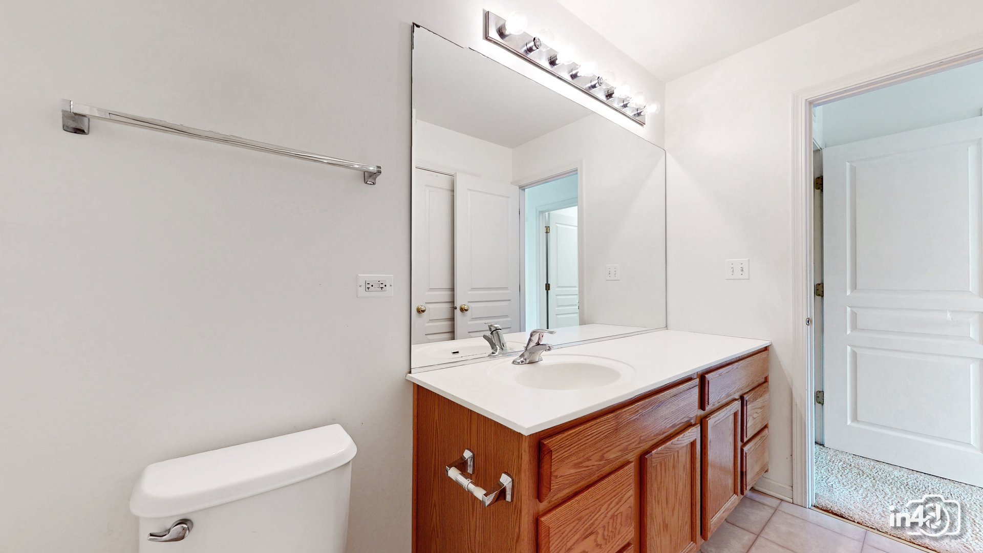 529 Metropolitan Street Aurora, IL 60502 - Photo 15 of 29 a bathroom with a sink a toilet and mirror