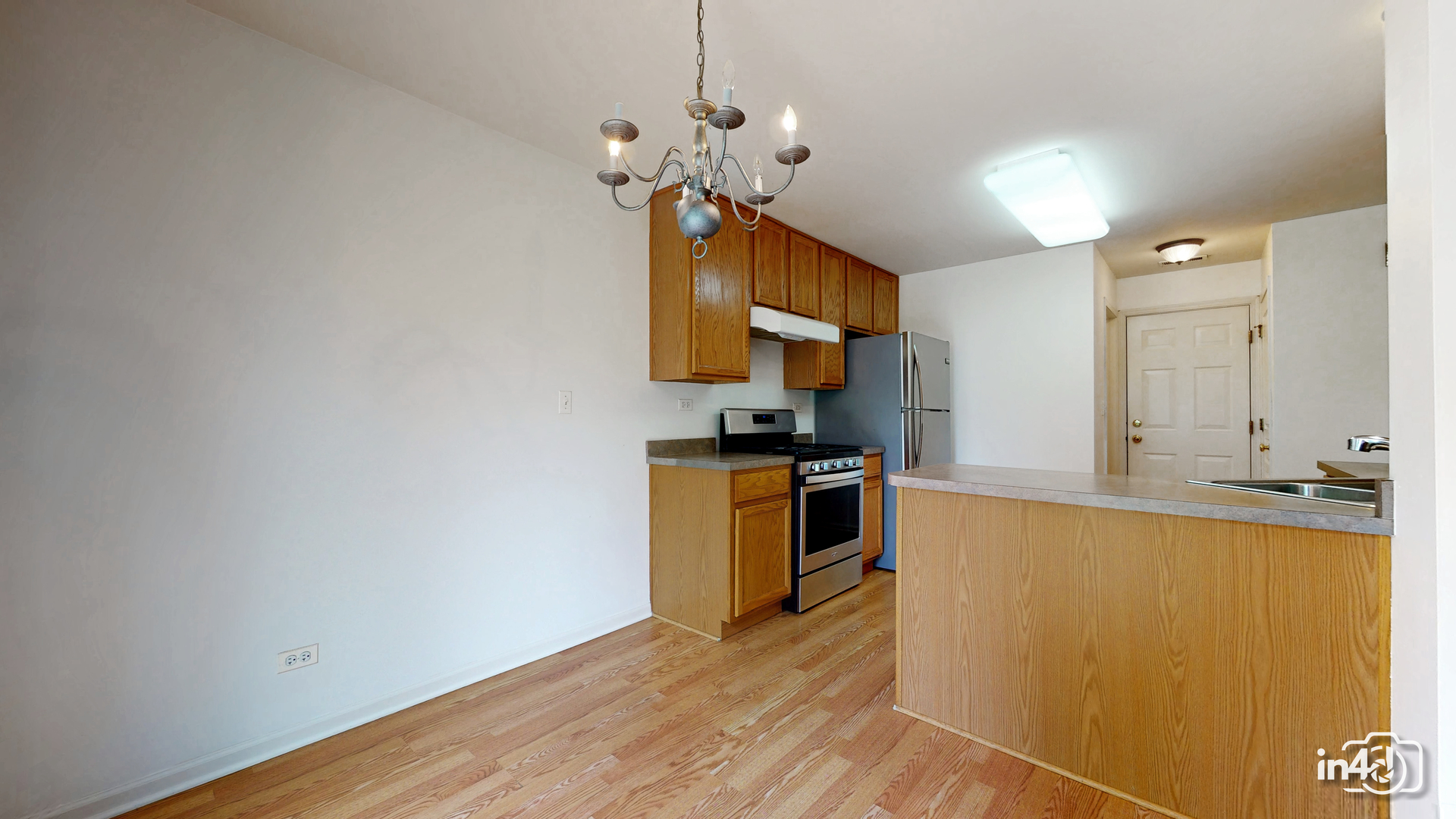 529 Metropolitan Street Aurora, IL 60502 - Photo 6 of 29 a kitchen with stainless steel appliances granite countertop a sink a stove and a refrigerator