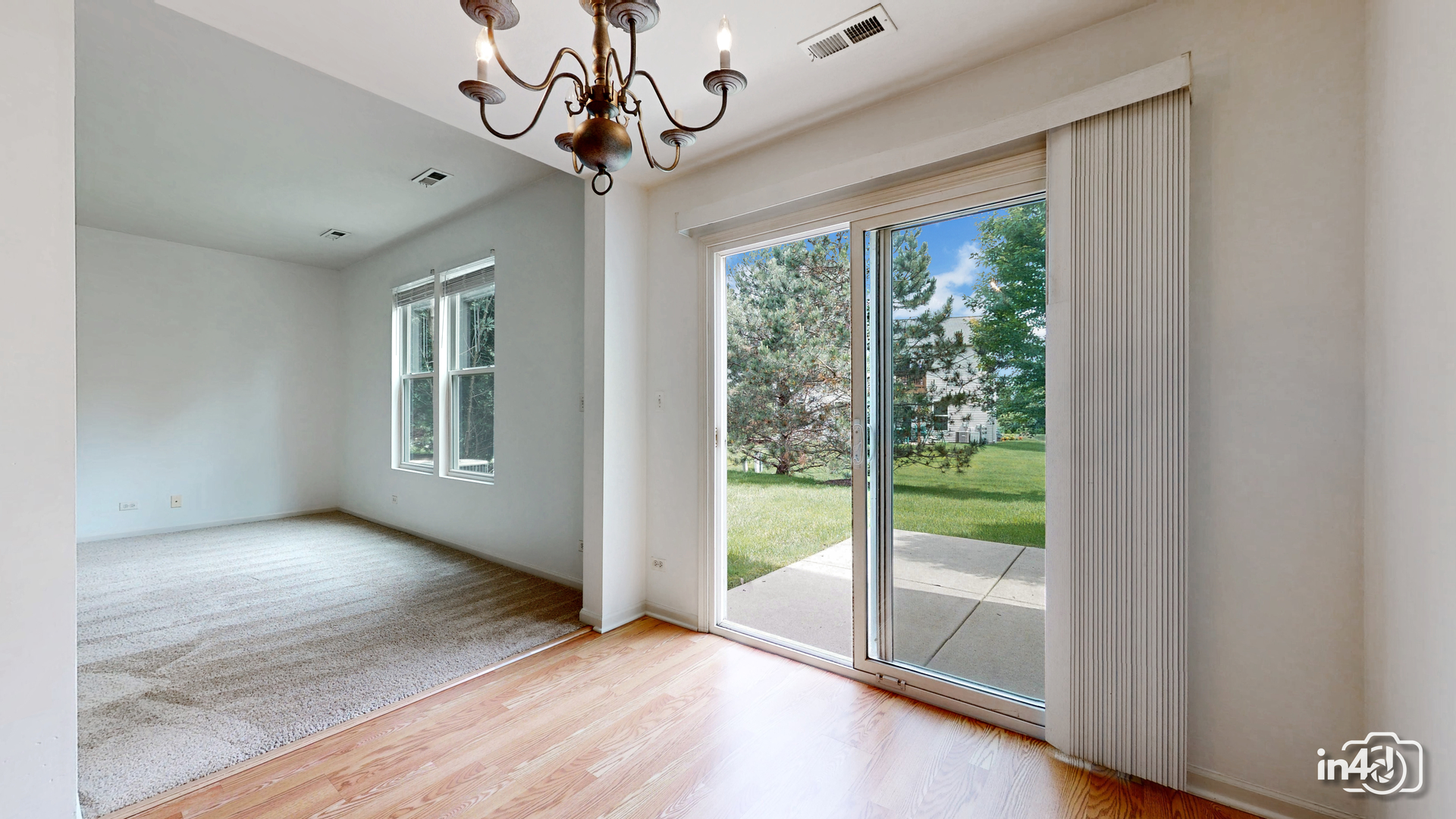 529 Metropolitan Street Aurora, IL 60502 - Photo 7 of 29 a view of a livingroom with wooden floor and a ceiling fan