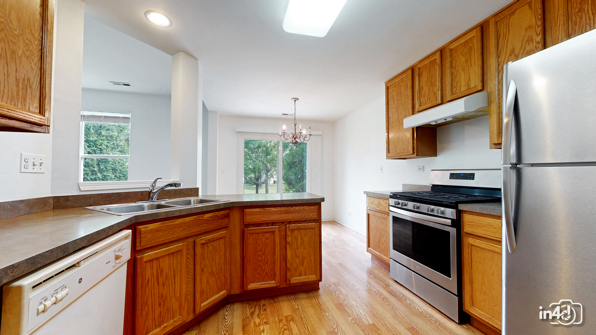 529 Metropolitan Street Aurora, IL 60502 - Photo 9 of 29 a kitchen with stainless steel appliances a stove a sink and a refrigerator