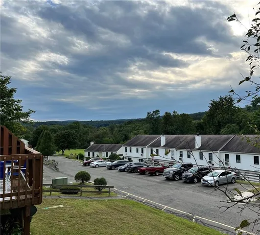 a view of a lake with couches and city view