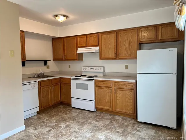 a kitchen with a sink cabinets and stainless steel appliances