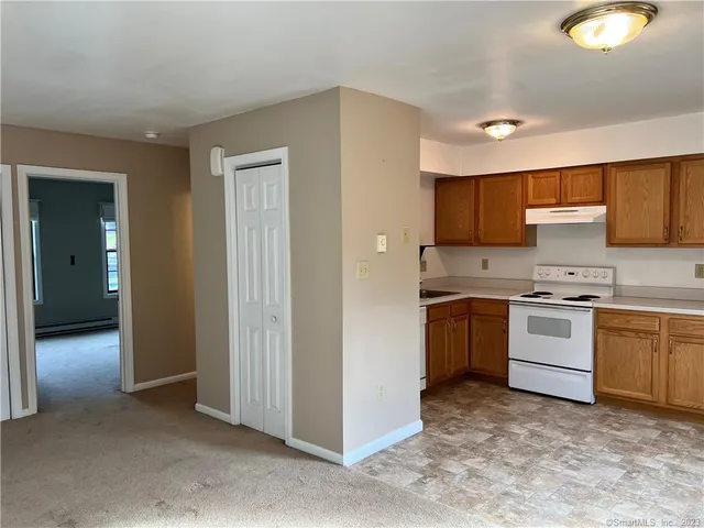 a kitchen with granite countertop a sink cabinets and stainless steel appliances