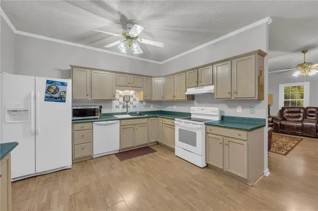 a kitchen with a white cabinets and window