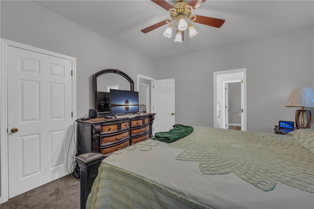 140 Breckenridge Lane Athens, GA 30606 - Photo 13 of 36 a bedroom with a bed and a chandelier