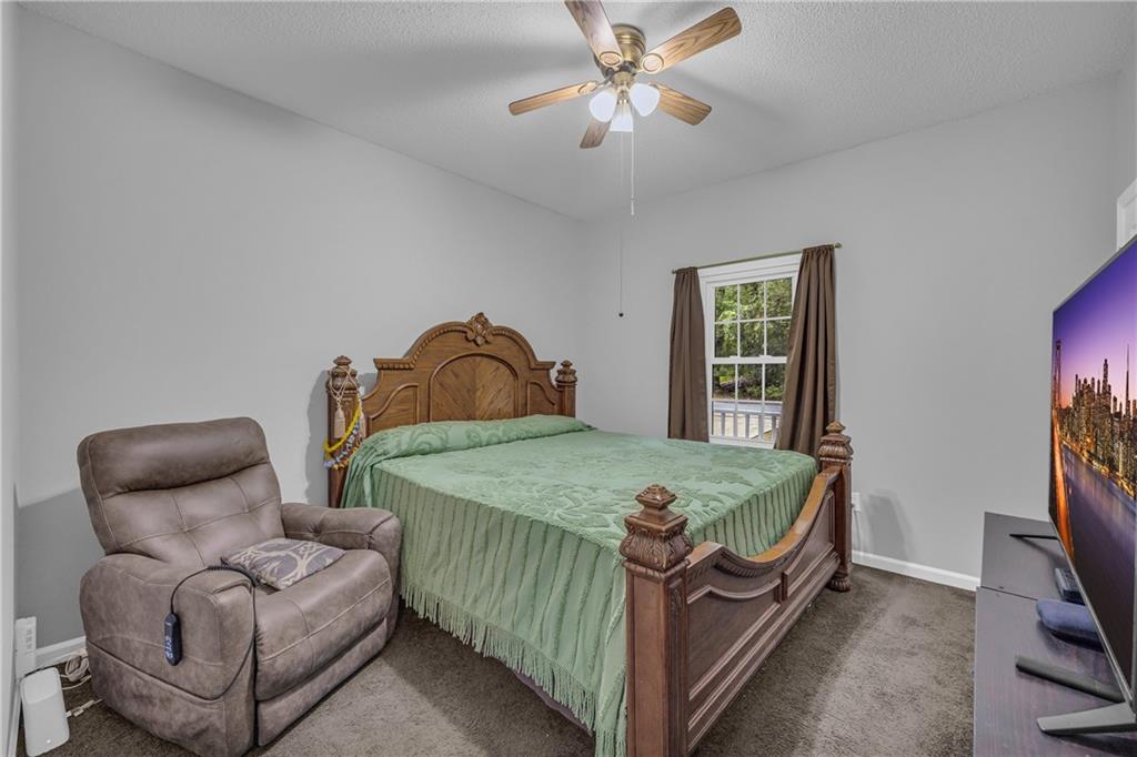 140 Breckenridge Lane Athens, GA 30606 - Photo 17 of 36 a bedroom with a bed and a chandelier