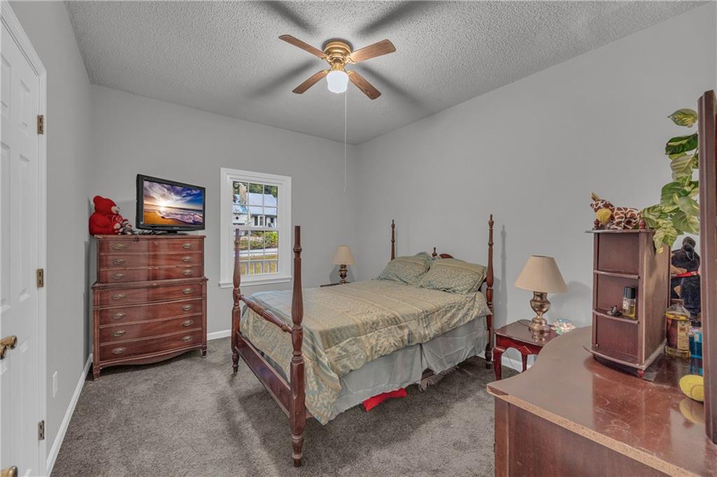 140 Breckenridge Lane Athens, GA 30606 - Photo 20 of 36 a bedroom with bed and a chandelier