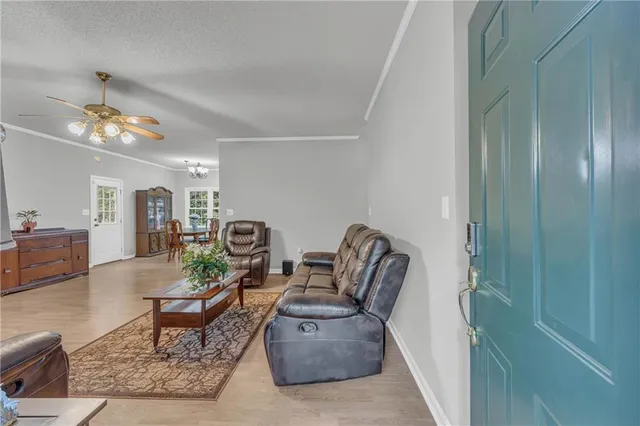 a living room with furniture and a chandelier