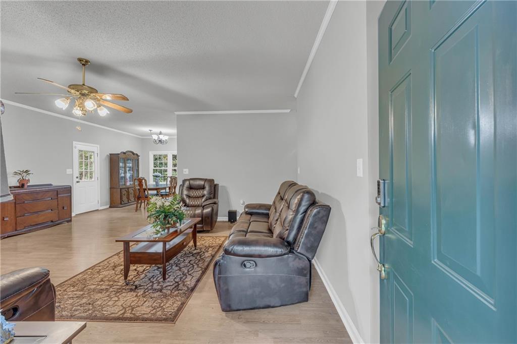 140 Breckenridge Lane Athens, GA 30606 - Photo 4 of 36 a living room with furniture and a chandelier