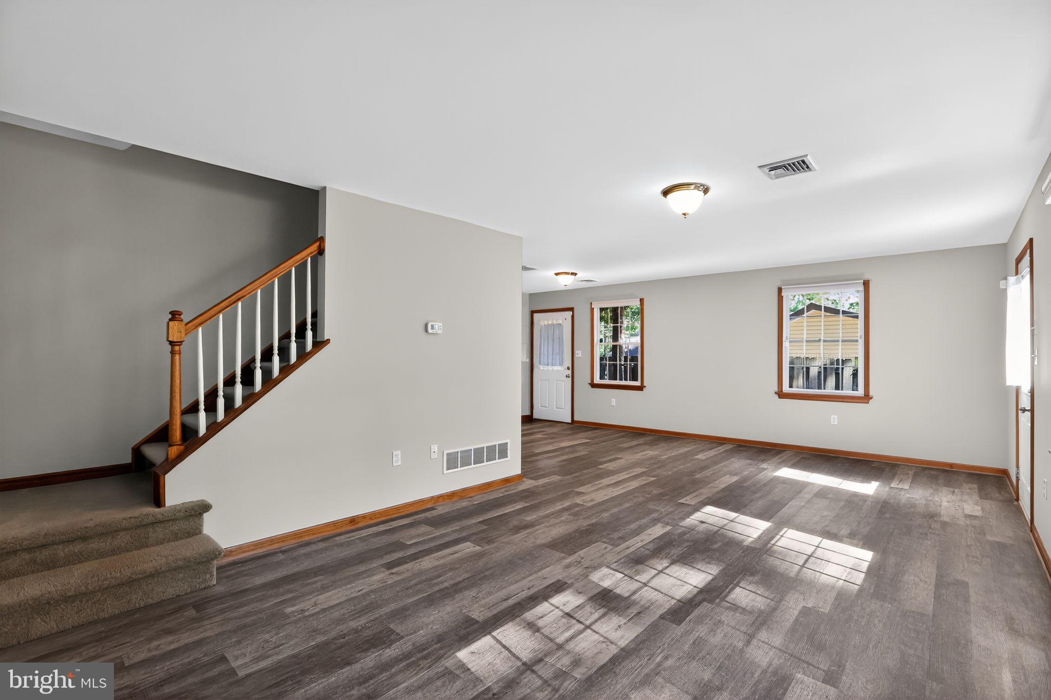 1709 Snyder Road Green Lane, PA 18054 - Photo 15 of 30 a view of an empty room with wooden floor and stairs