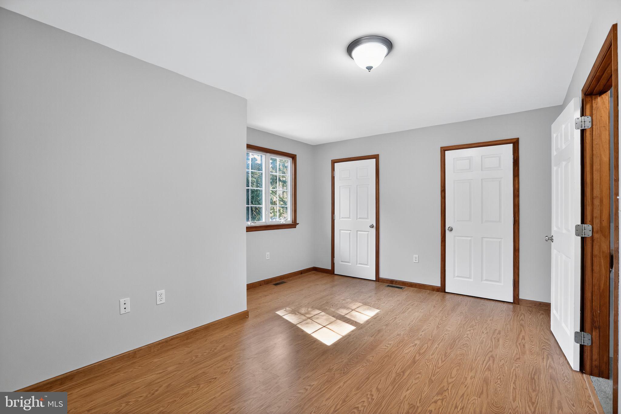 1709 Snyder Road Green Lane, PA 18054 - Photo 19 of 30 an empty room with wooden floor and windows