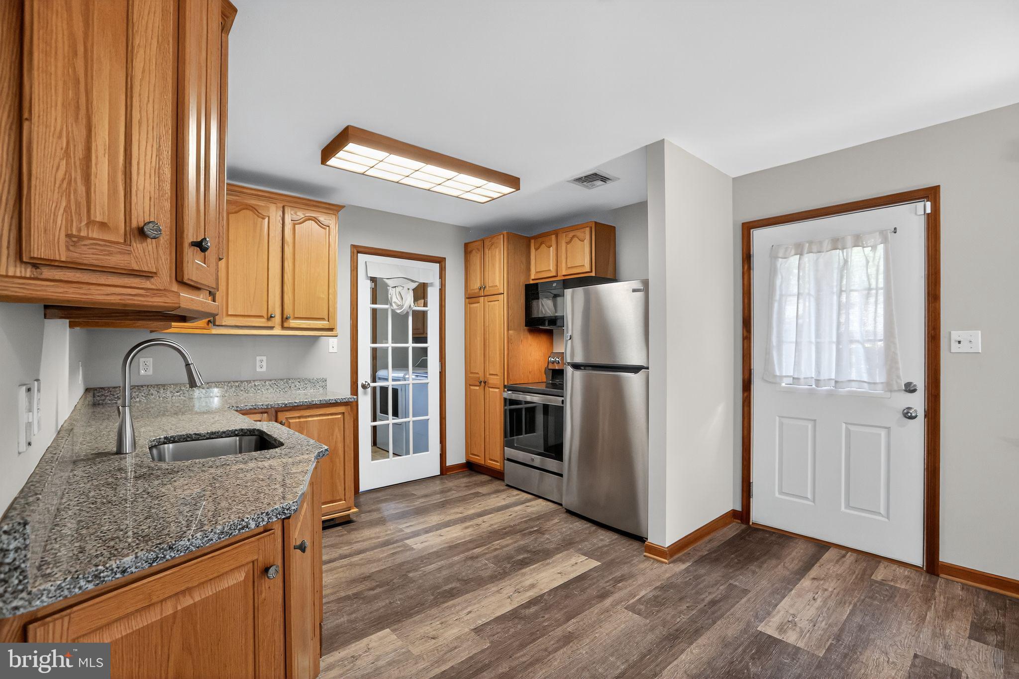 1709 Snyder Road Green Lane, PA 18054 - Photo 4 of 30 a kitchen with granite countertop a refrigerator and a sink