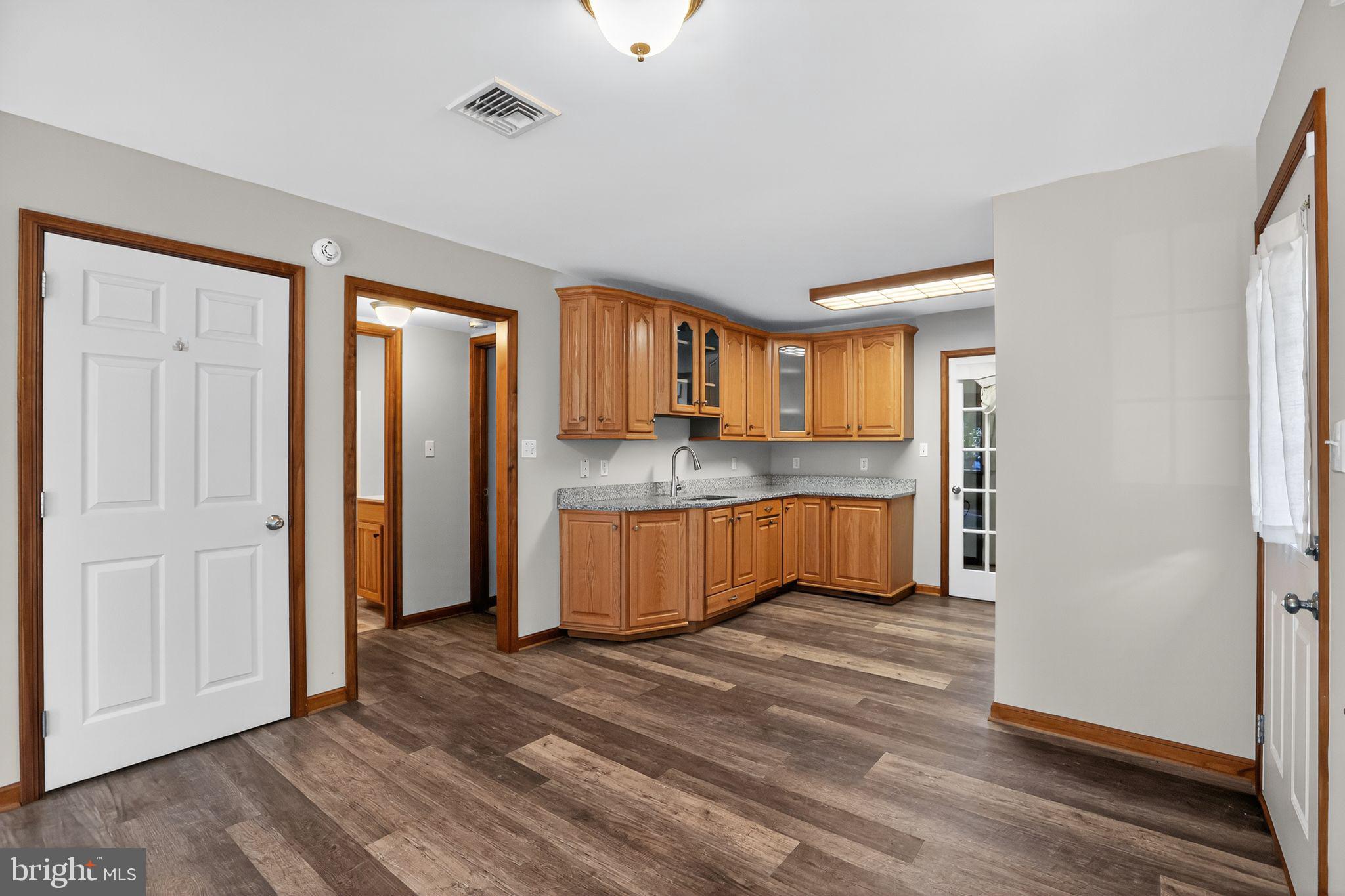 1709 Snyder Road Green Lane, PA 18054 - Photo 5 of 30 a large kitchen with a refrigerator a sink dishwasher and a stove with wooden floor