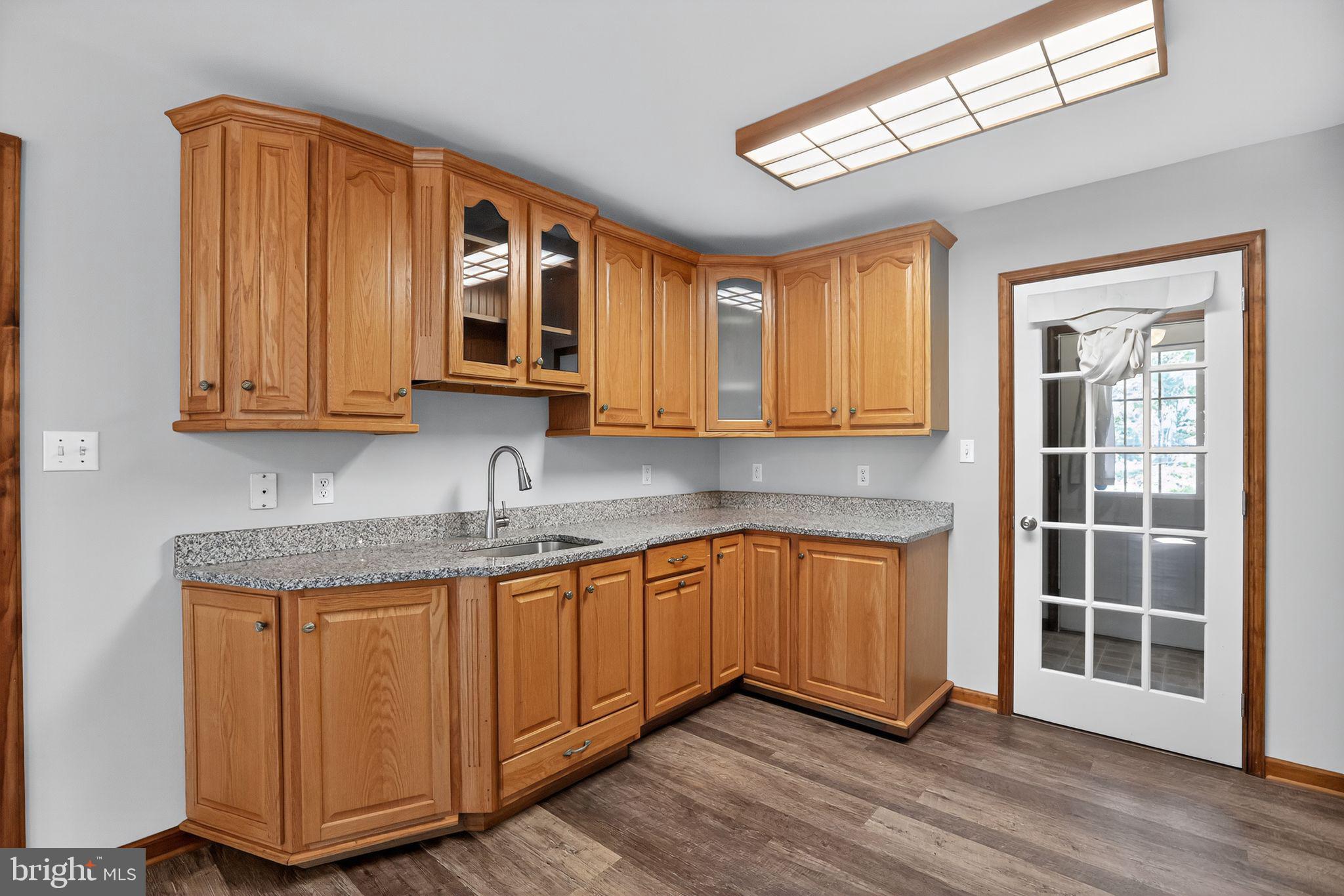 1709 Snyder Road Green Lane, PA 18054 - Photo 7 of 30 a kitchen with stainless steel appliances granite countertop a sink and wooden cabinets