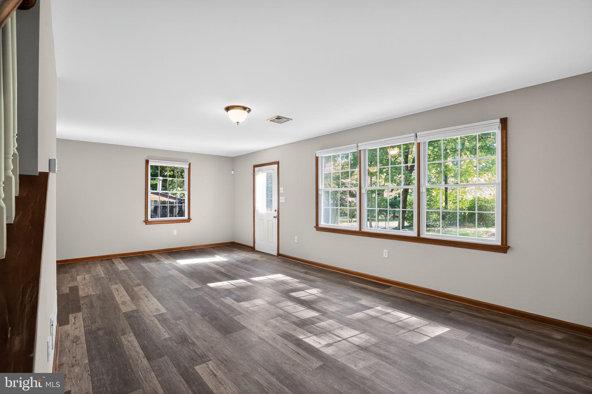 1709 Snyder Road Green Lane, PA 18054 - Photo 8 of 30 a view of an empty room with wooden floor and a window