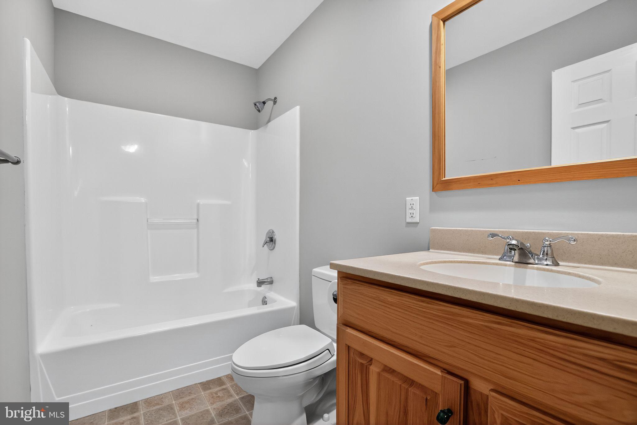 1709 Snyder Road Green Lane, PA 18054 - Photo 9 of 30 a bathroom with a sink a toilet and a bathtub