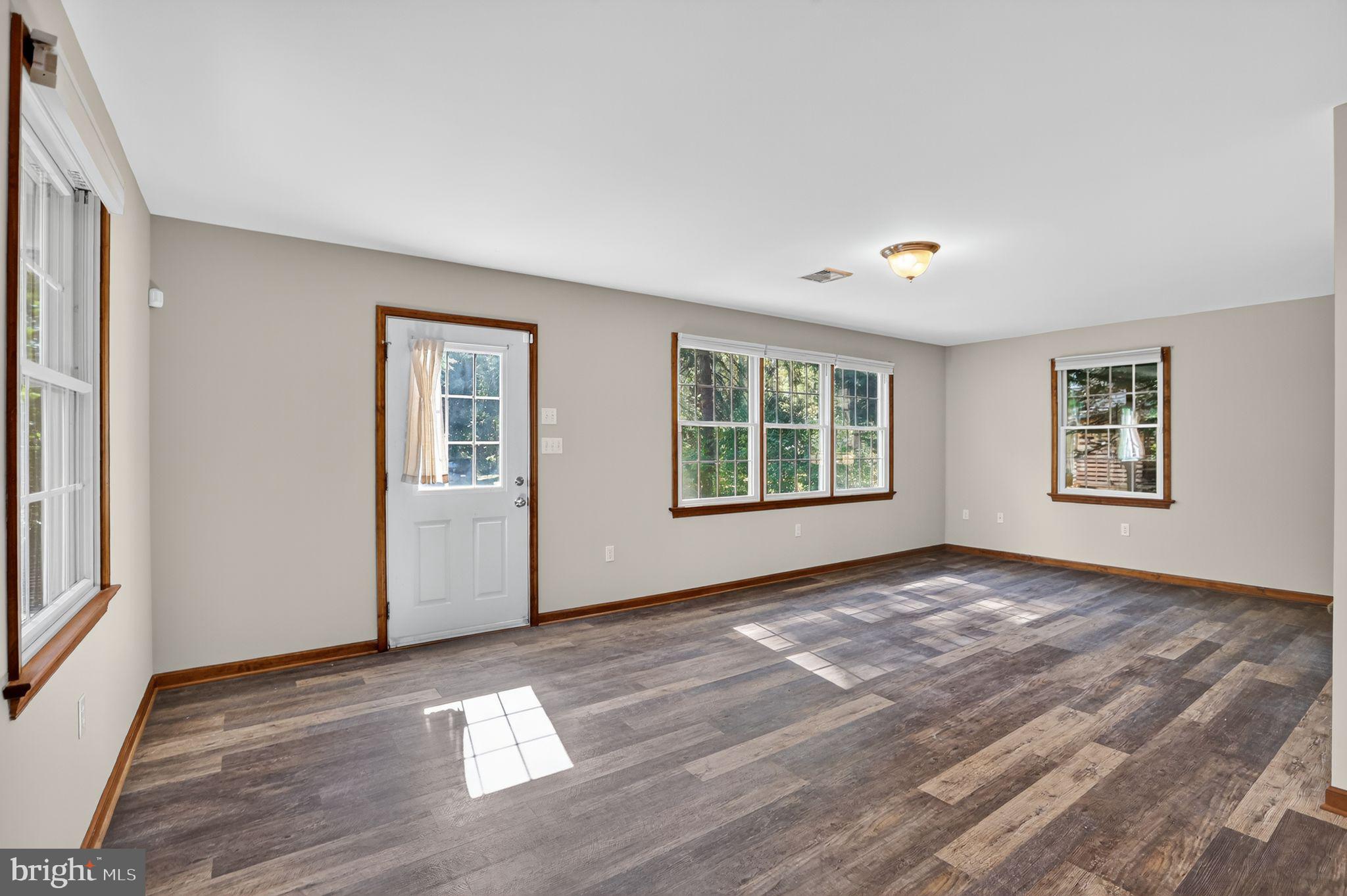 1709 Snyder Road Green Lane, PA 18054 - Photo 10 of 30 a view of an empty room with window and wooden floor