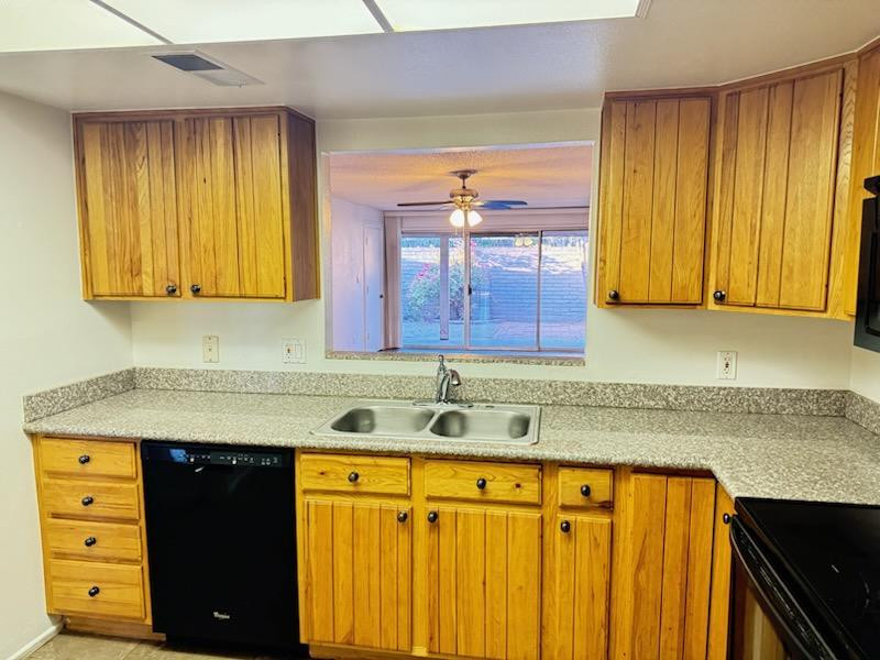 5126 East Monte Vista Road Phoenix, AZ 85008 - Photo 3 of 22 a kitchen with a sink a stove and cabinets