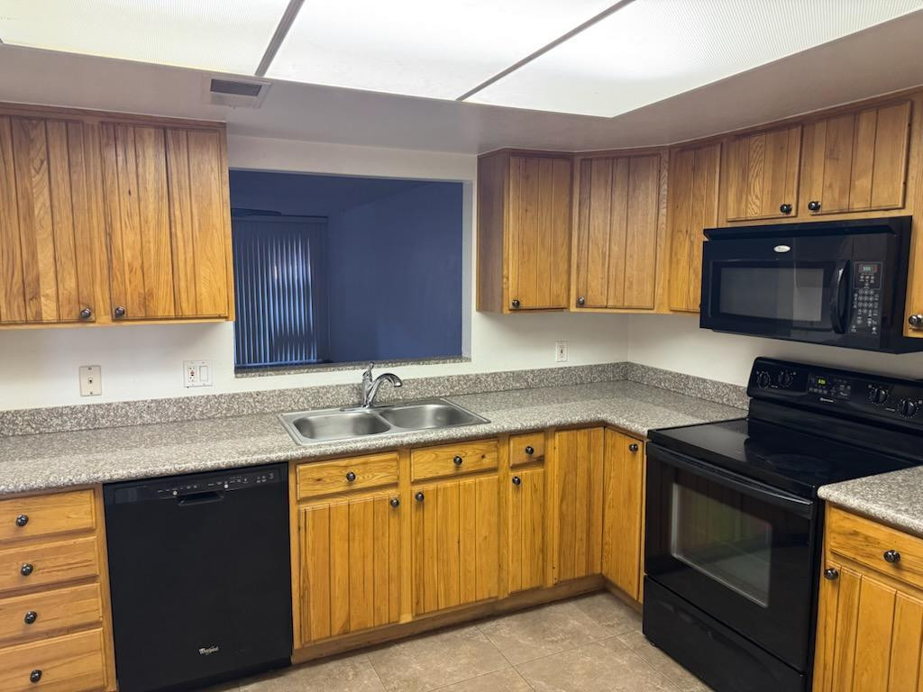 5126 East Monte Vista Road Phoenix, AZ 85008 - Photo 4 of 22 a kitchen with granite countertop wooden cabinets stainless steel appliances and a window
