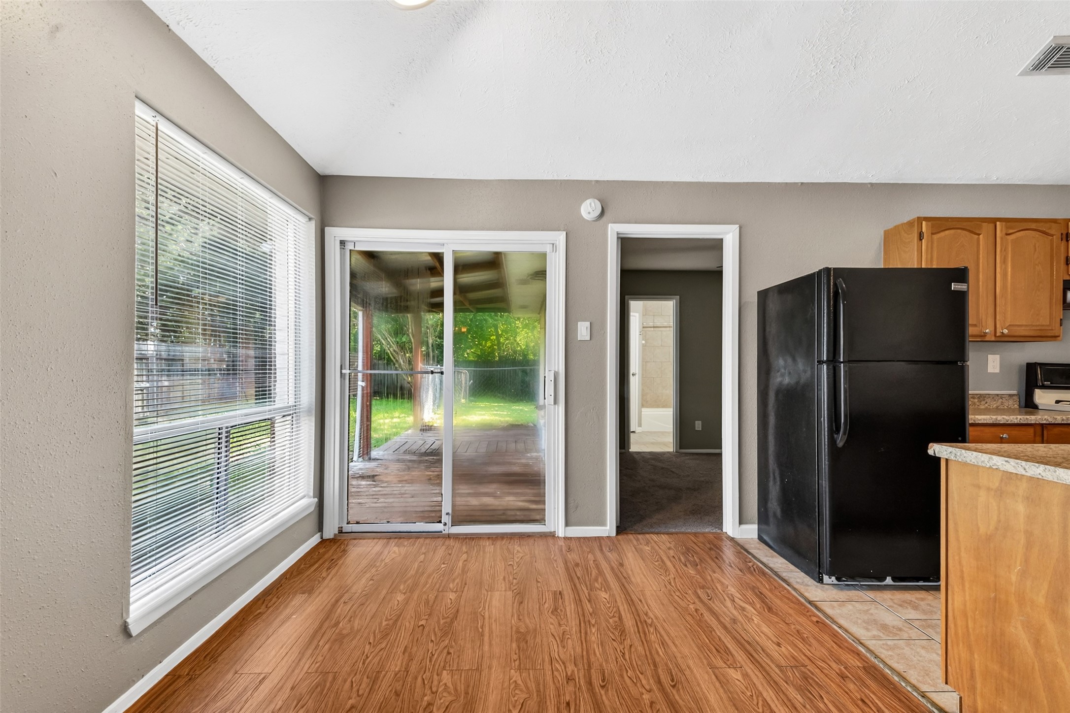 3119 Oak Rock Spring, TX 77373 - Photo 10 of 25 a view of empty room with wooden floor and a floor to ceiling window