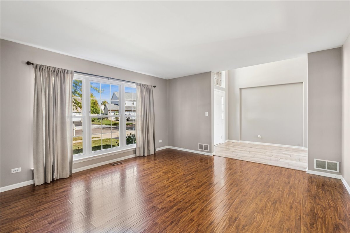 2308 Loop Road Algonquin, IL 60102 - Photo 13 of 73 an empty room with wooden floor and windows