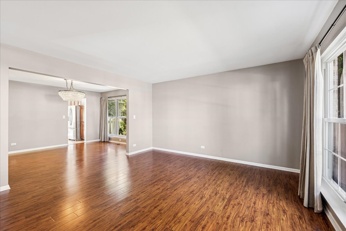 2308 Loop Road Algonquin, IL 60102 - Photo 15 of 73 a view of an empty room with window and wooden floor