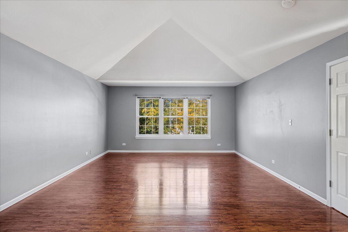 2308 Loop Road Algonquin, IL 60102 - Photo 22 of 73 a view of an empty room with wooden floor and a window