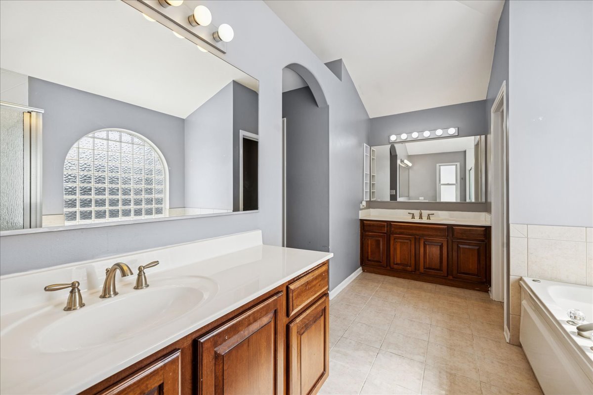 2308 Loop Road Algonquin, IL 60102 - Photo 25 of 73 a spacious bathroom with a granite countertop sink a mirror and a bathtub
