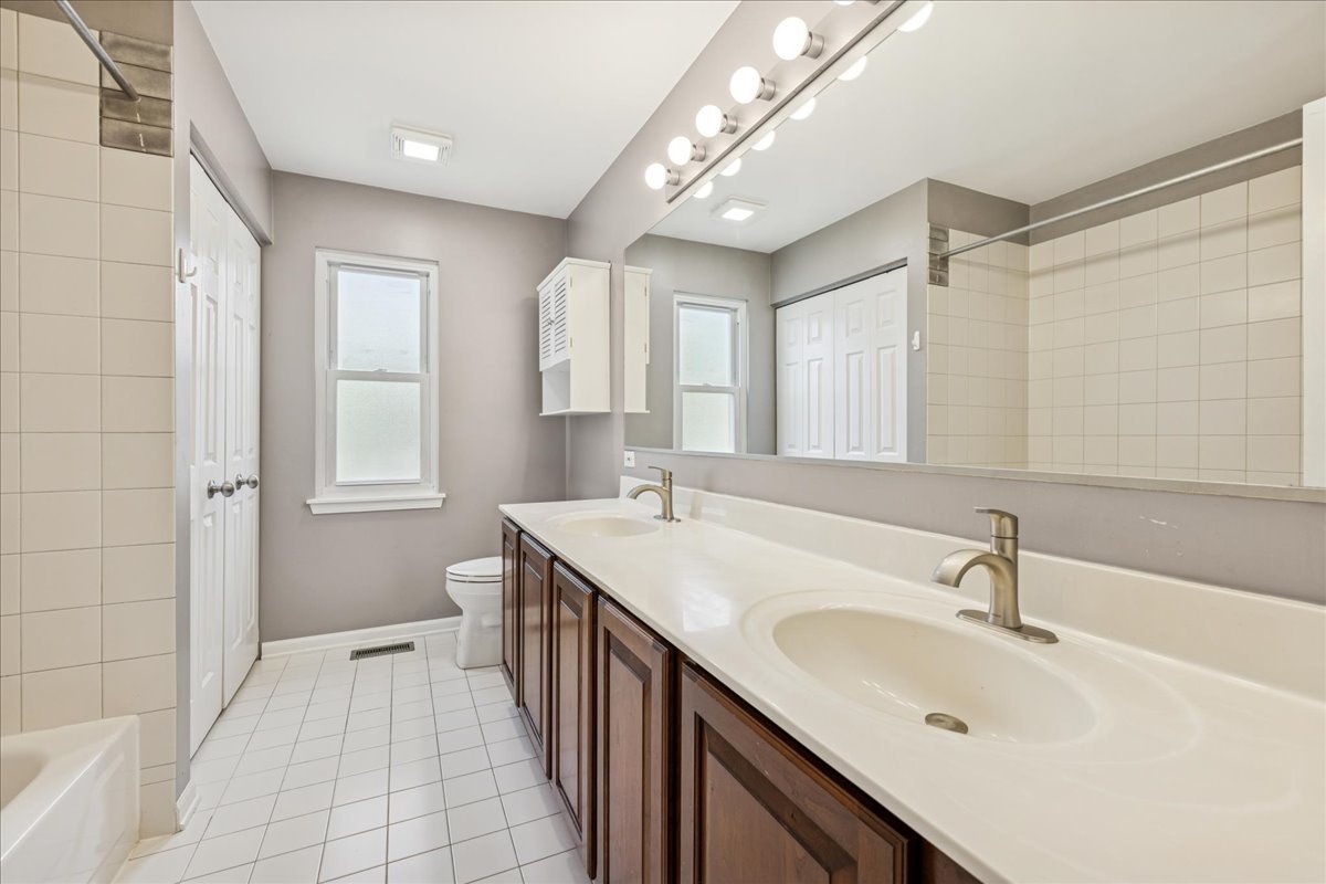 2308 Loop Road Algonquin, IL 60102 - Photo 28 of 73 a bathroom with a sink a toilet a mirror and shower