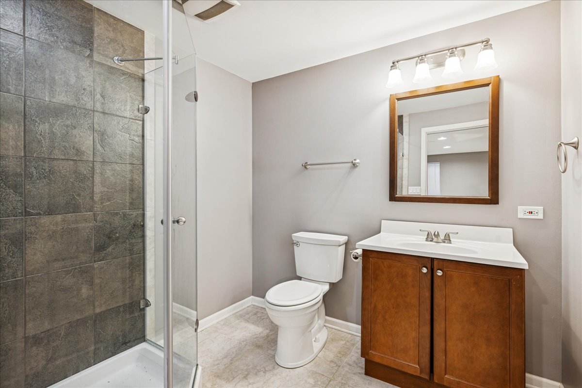 2308 Loop Road Algonquin, IL 60102 - Photo 35 of 73 a bathroom with a toilet a sink and mirror