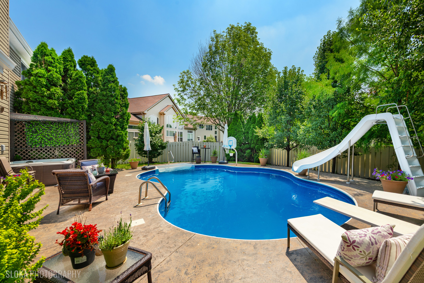 2308 Loop Road Algonquin, IL 60102 - Photo 44 of 73 a view of a swimming pool with a lounge chair and a fire pit