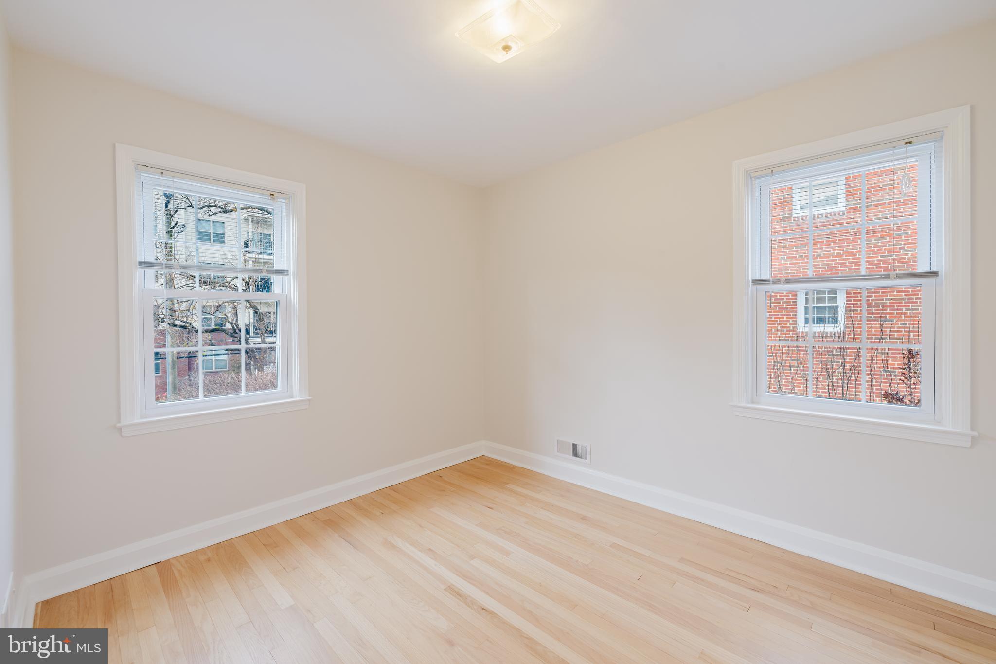 904 Locustvale Road Towson, MD 21204 - Photo 11 of 29 a view of an empty room with wooden floor and a window