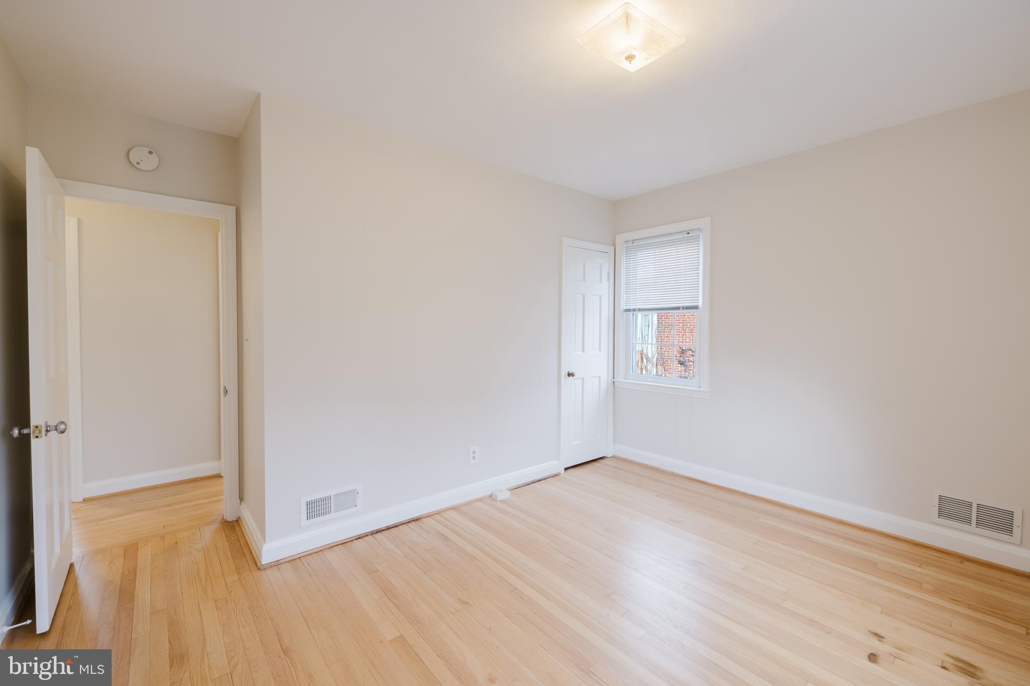 904 Locustvale Road Towson, MD 21204 - Photo 12 of 29 an empty room with wooden floor and windows
