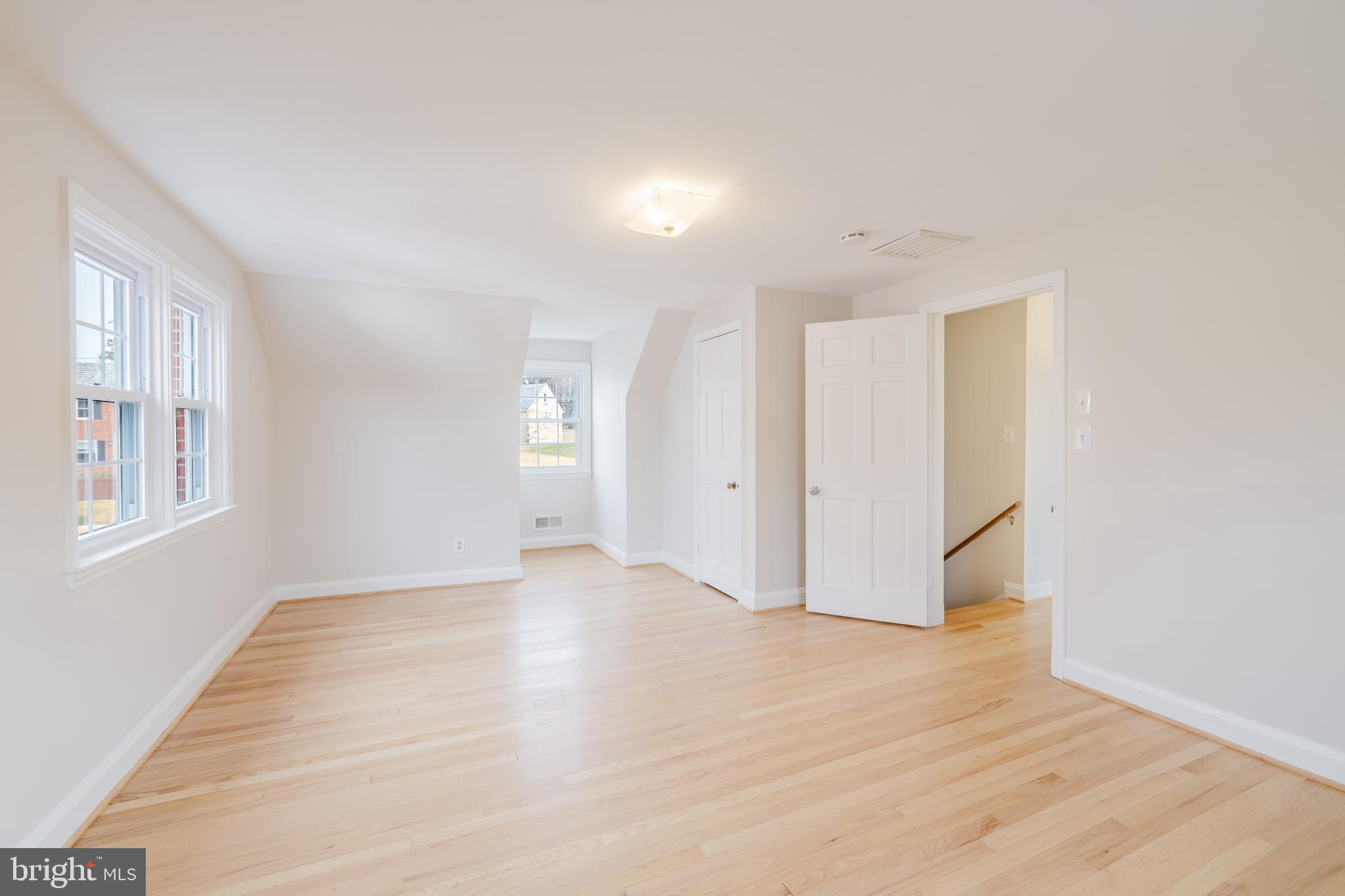 904 Locustvale Road Towson, MD 21204 - Photo 15 of 29 a view of an empty room with wooden floor and a window