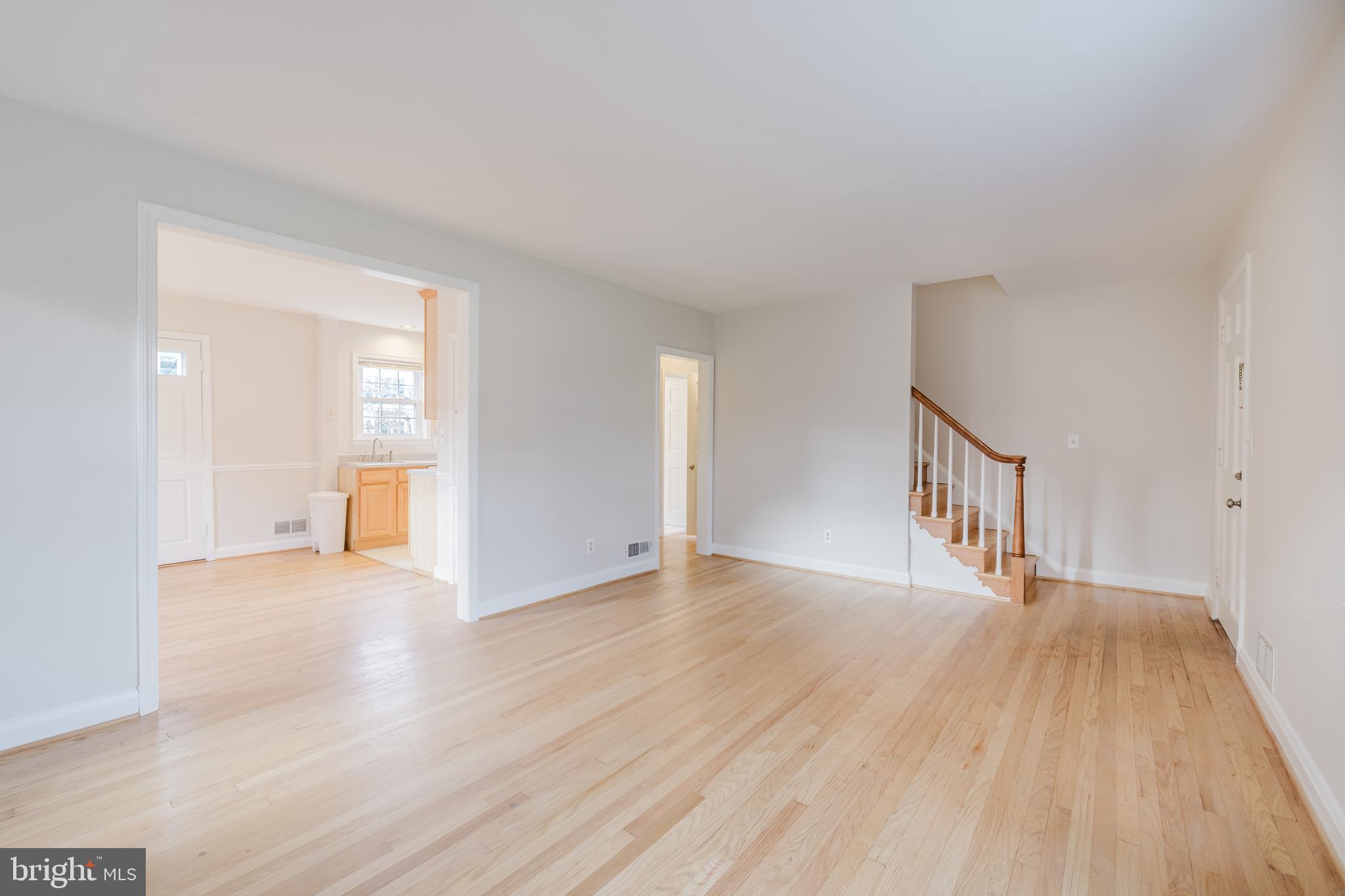 904 Locustvale Road Towson, MD 21204 - Photo 5 of 29 a view of an empty room with wooden floor and a window