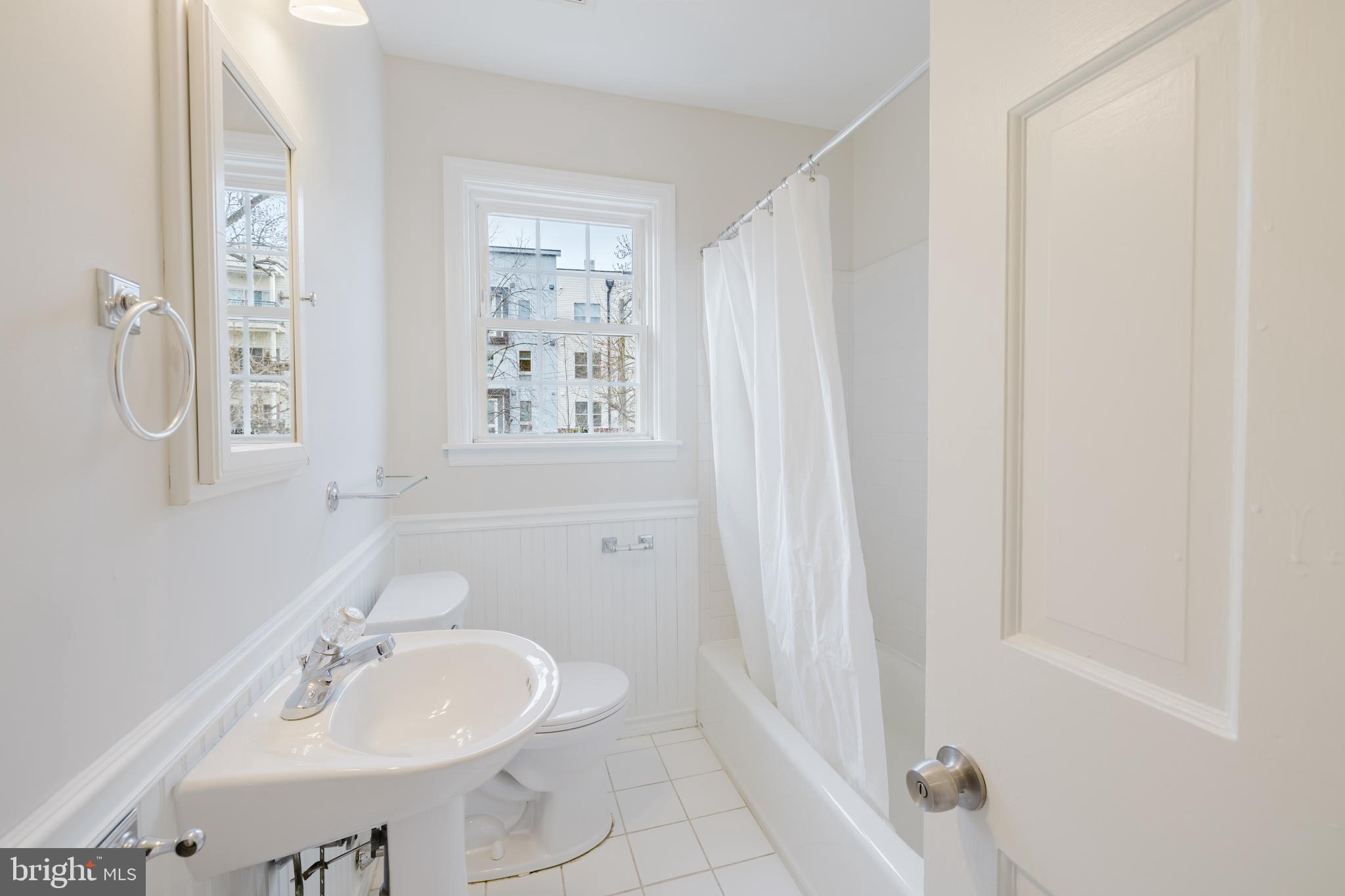 904 Locustvale Road Towson, MD 21204 - Photo 10 of 29 a bathroom with a sink a mirror and a shower